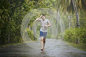 Man running on road in rain