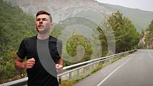 Man running at run ultra marathon in mountains. Athletic sportive male runner exercising and training outdoors, doing endurance ru