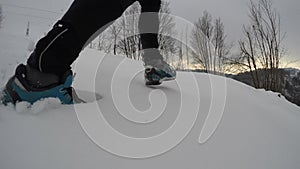 Man running on a snowed mountain in winter