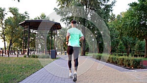 man running in sportswear outdoor back view, sport