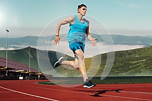 Man running in the track. Fit male fitness runner jogging in stadium photo