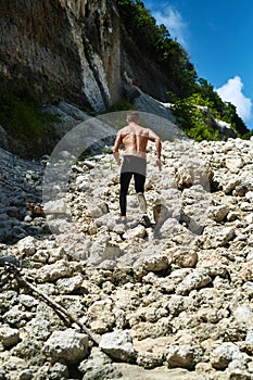 Man Running Up Rocky Hill, Exercising During Outdoor Workout. Sport