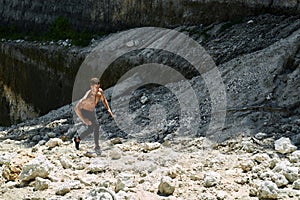 Man Running Up Rocky Hill, Exercising During Outdoor Workout. Sport