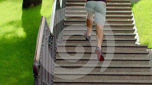 Man running up stairs. Fitness man running upstairs in park