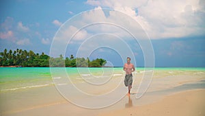 Man runs along tropical beach