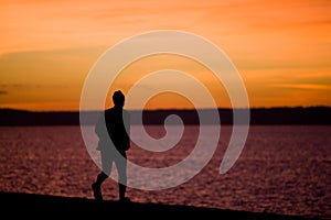 A man runs along the waterfront at Alki Beach