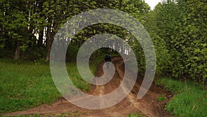 Man runs away on a dirt road.