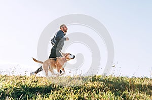 Man runs with his beagle dog. Morning Canicross exercise photo