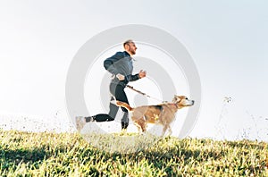 Man runs with his beagle dog. Morning Canicross exercise concept image photo