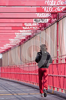 Man runs over the Williamsburg bridge.