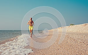 Man runs on the sea surf line