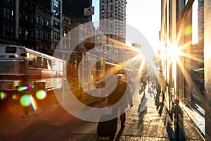 Man rushing down the sidewalk in Manhattan New York City with sunlight background photo