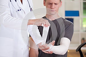 Man's aching hand at consulting room photo