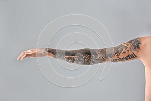 Man`s arm with stylish tattoos