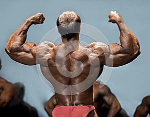 Man's back double biceps pose.