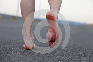 Man's bare feet walking away