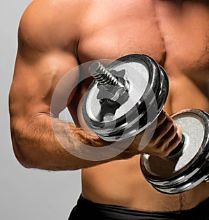 Man's body with metal dumbbell