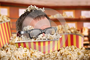 Man's in a bucket of popcorn