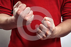The man`s clenched fists. aggression, domestic or family violence