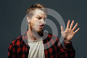 Man`s crazy face crushed on transparent glass