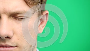 Man's eyes, close-up, on a green background