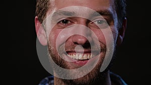 Man`s Face Against a Black Background