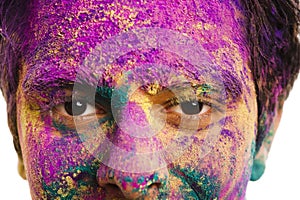 Man's face covered with powder paint during Holi festival