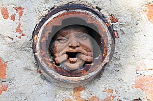 Man`s face in hole at brick wall in Melbourne.