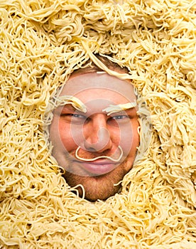Man's face in pasta, closeup
