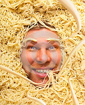 Man's face in pasta, closeup