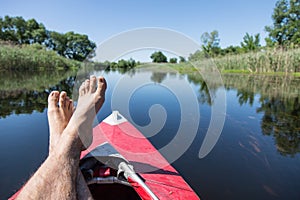 Man's feet over canoe.