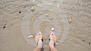 Man`s feet on the sand beach