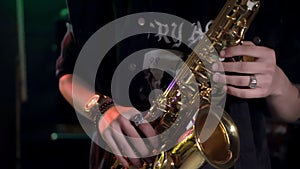 Man`s fingers playing on the saxophone beautiful blues melody. Closeup