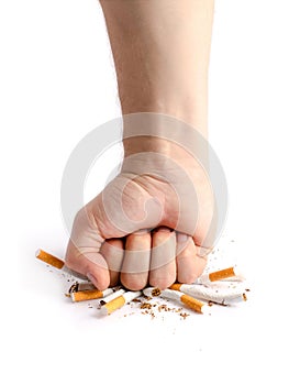 Man's fist crushing cigarettes