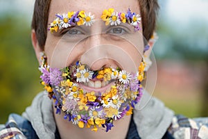 Man\'s flowery face reflects nature\'s intrinsic bond