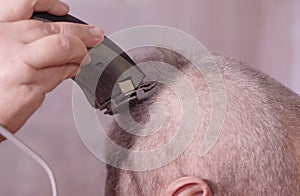 A man is cut hair on his head.The man`s hairstyle in hairdressing salon