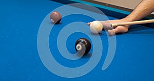 of a man's hand on a billiard table, playing snooker