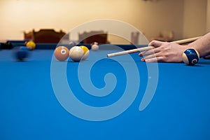 of a man's hand on a billiard table, playing snooker
