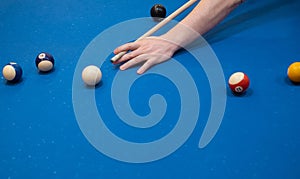 of a man's hand on a billiard table, playing snooker