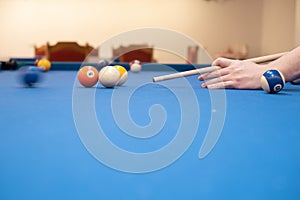 of a man's hand on a billiard table, playing snooker