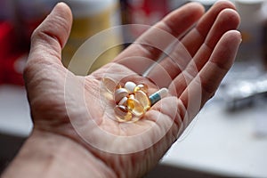 Man`s hand with a bunch of pills