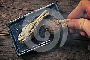 Man burning white sage incense photo