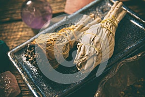 Man burning white sage incense photo