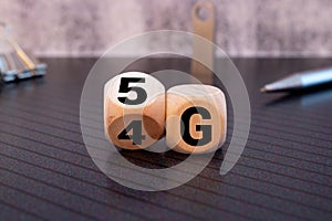 Man's Hand Changing Wooden Block From 4g To 5g On White Surface