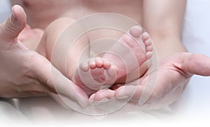 Man's hand and children's foot