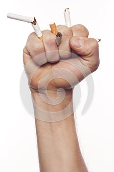 Man's hand crushing cigarettes