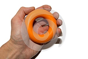 Man`s hand with expander. Means to strengthen the muscles of the hand. Strength training.