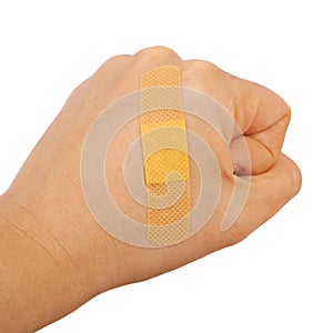On a man's hand fist glued medical plaster first aid plaster ad