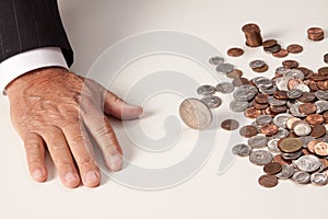 Man's hand flat after tossing coin that is spinning