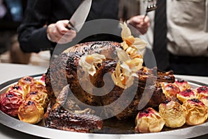 Man's hand with fork and knife with turkey